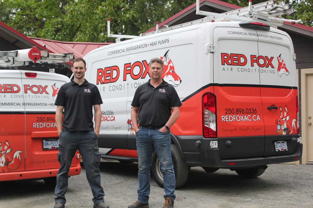 Red Fox Heating technician installing a heat pump system