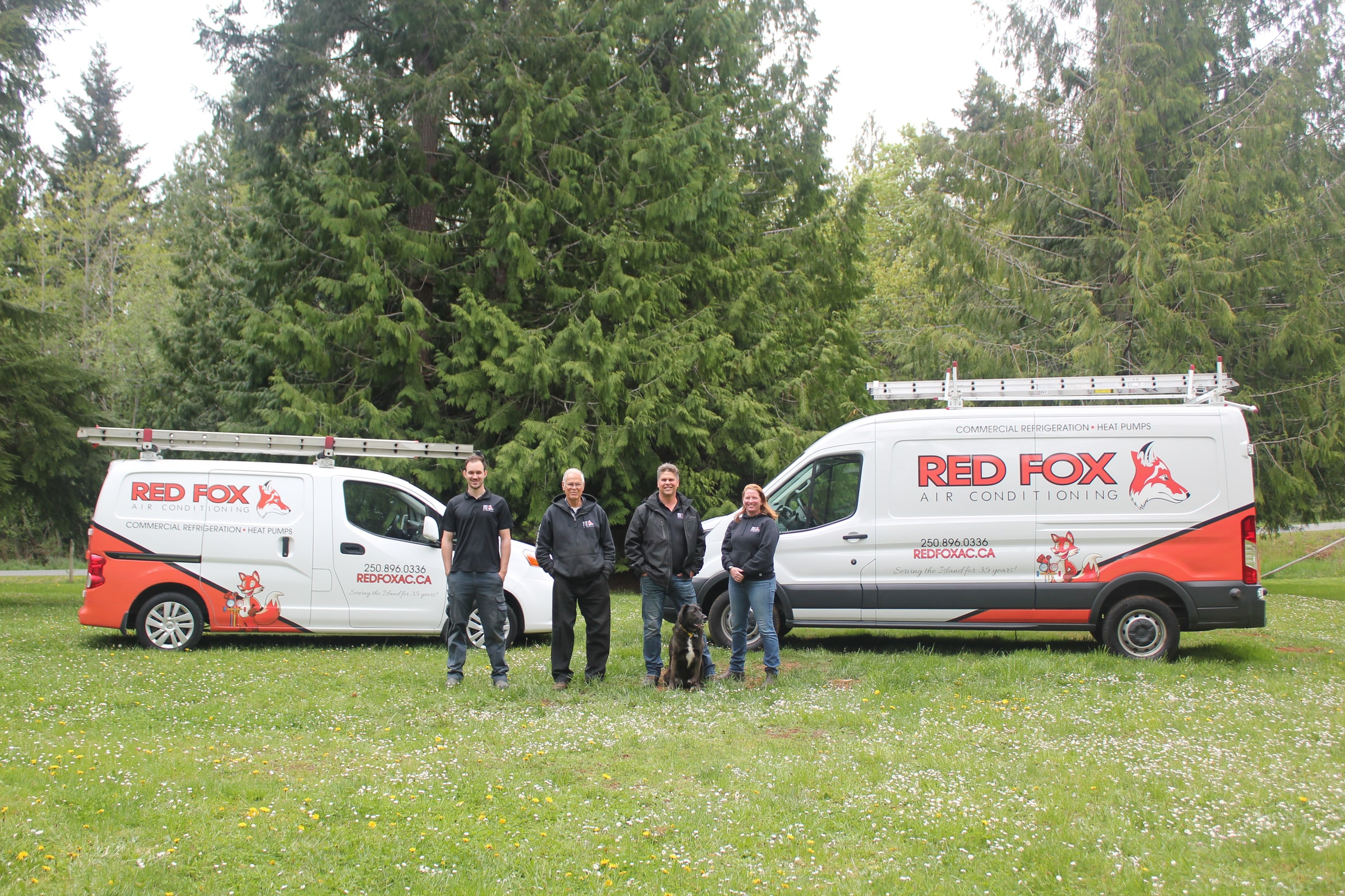The Red Fox team in front of our branded service vans, Greater Victoria